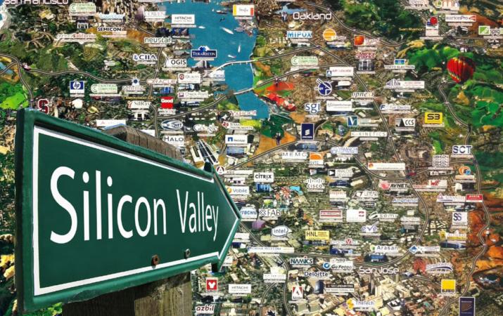 Green 'Silicon Valley' road sign pointing over an aerial map of the San Francisco Bay Area studded with technology-company logos. Third-party editorial image.