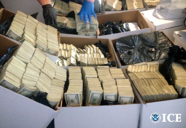 Boxes of U.S. banknotes seized in a drug-trafficking investigation, with the ICE logo