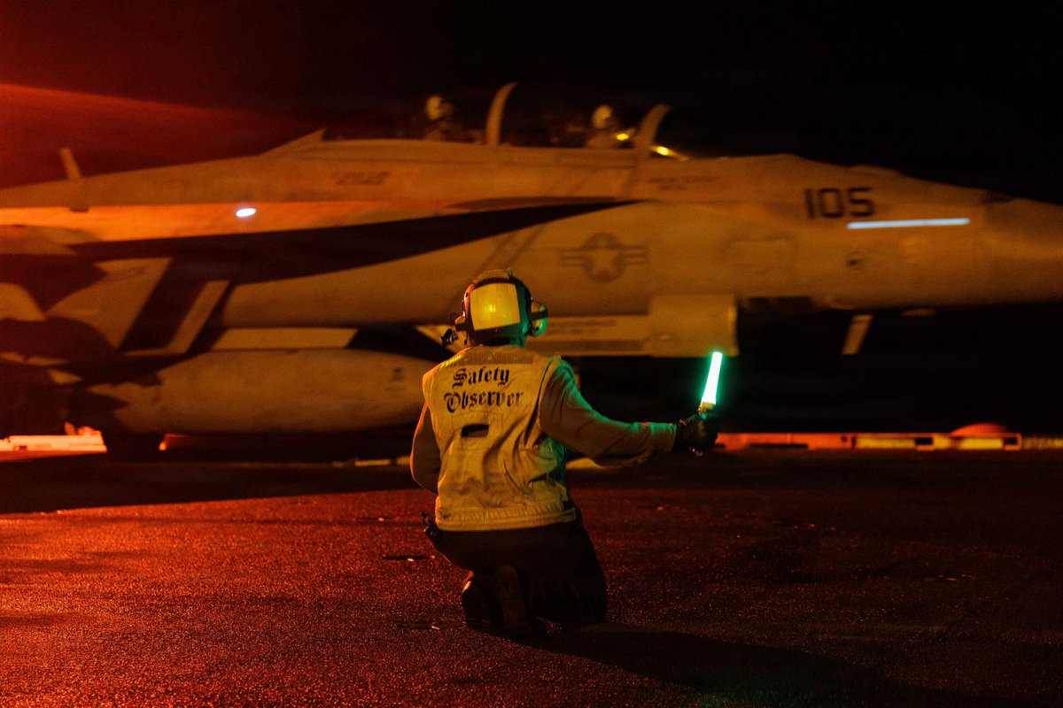 F/A-18 on a carrier flight deck at night (US CENTCOM)