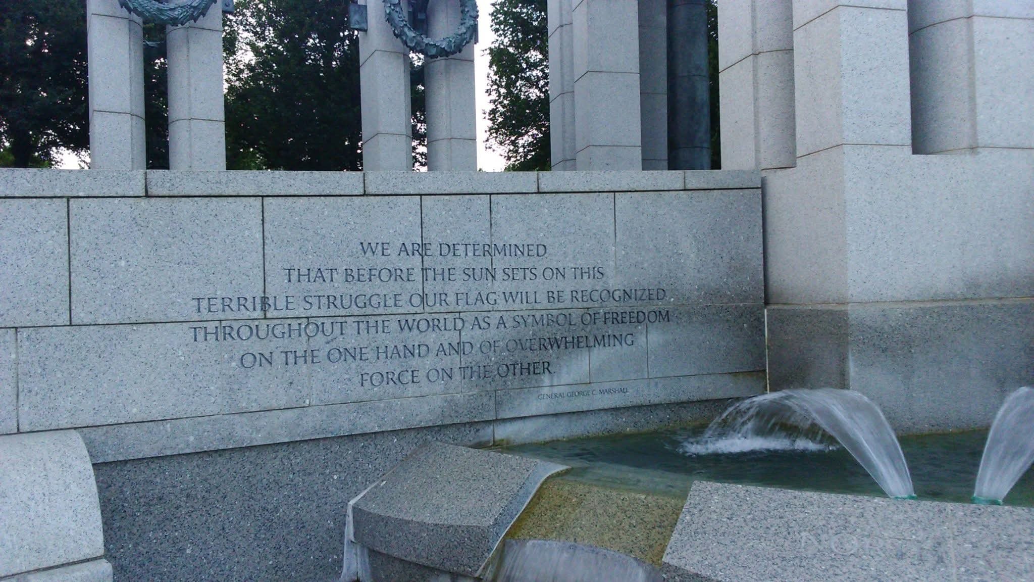 Engraved General George C. Marshall quote on freedom and force at a Washington, D.C. memorial, with fountains