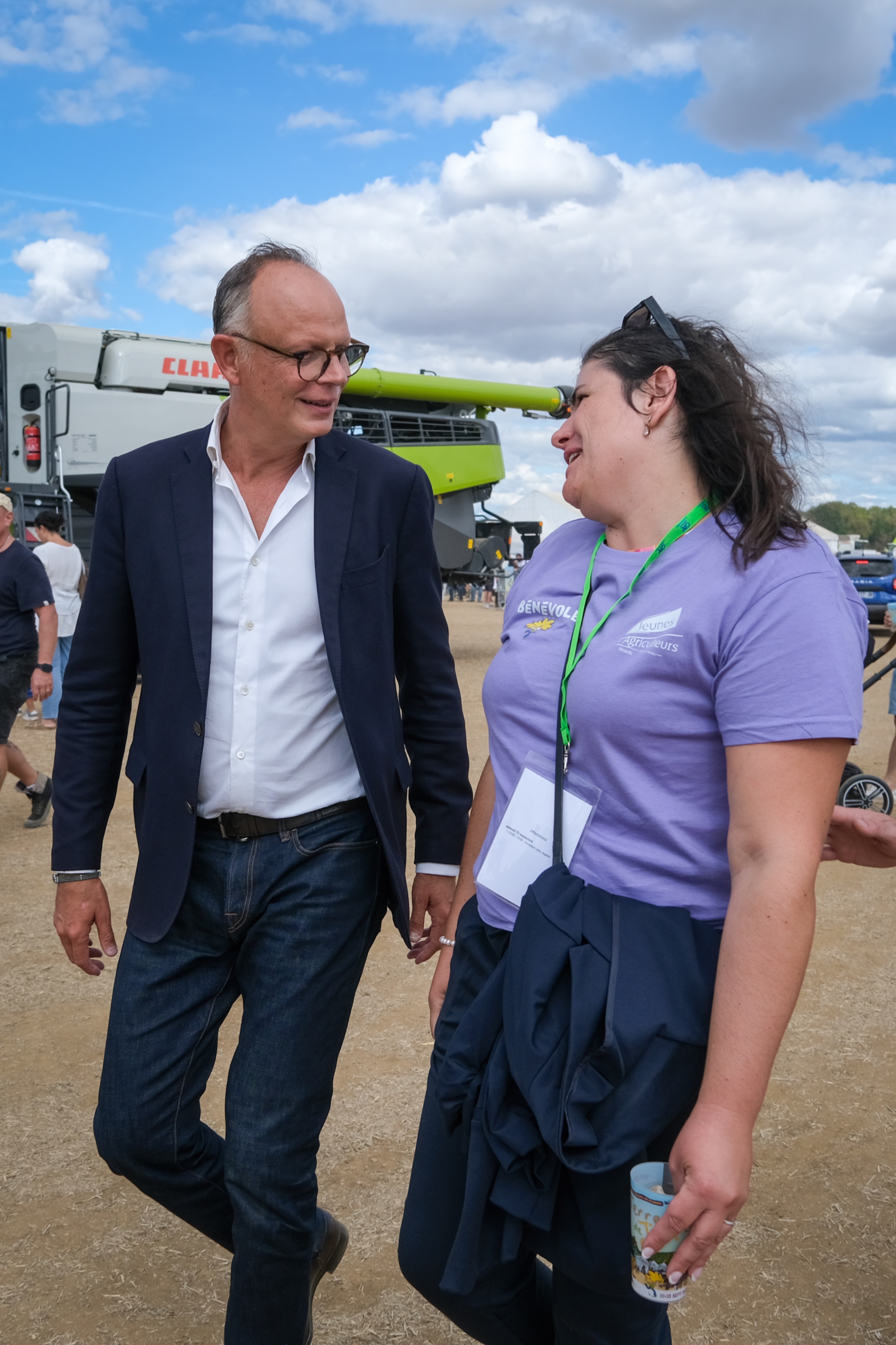 Edouard Philippe talks with a voter at an agricultural fair
