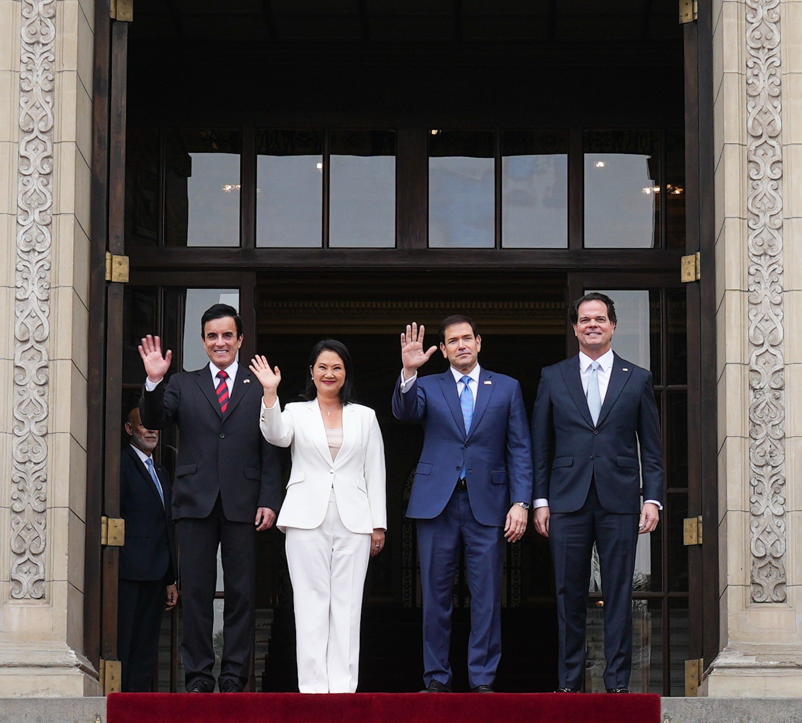 Marco Rubio and members of the U.S. and Peruvian delegations wave from the entrance of a government palace in Lima
