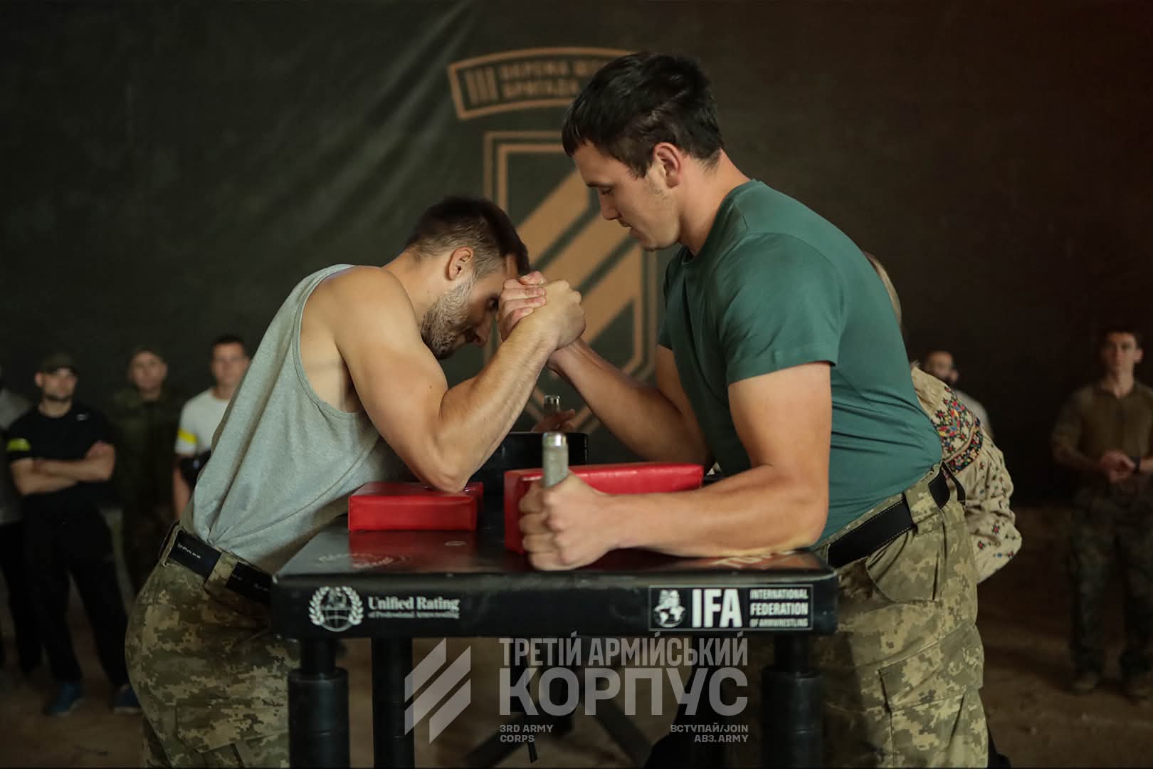 Soldiers arm-wrestle at a Third Army Corps unit event